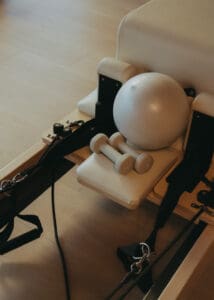 Pilates reformers arranged inside Solace Studio in Orlando with warm lighting and arched mirrors for wellness branding photography.