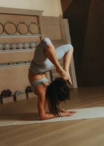 Advanced Pilates pose performed on mat inside Solace Studio, photographed for fitness branding and studio marketing imagery.