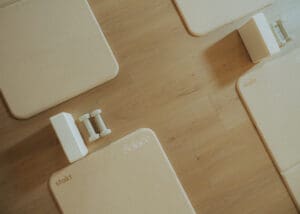 Minimalist wellness detail photo of Pilates mats, dumbbells, and yoga block arranged on wood floors inside Solace Studio.