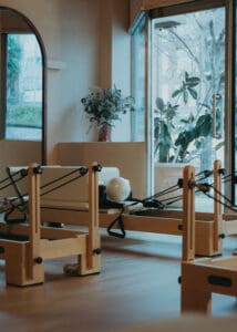 Pilates reformers lined up inside neutral-toned wellness studio photographed for Solace Studio branding photography in Orlando.