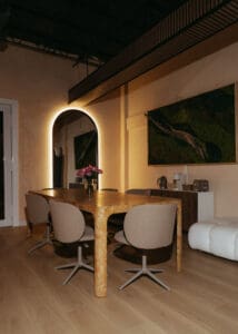 Solace Studio lounge and meeting space with wood table, chairs, and warm natural light photographed for Orlando wellness branding photography.