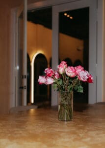 Solace Studio lounge and meeting space with wood table, chairs, and warm natural light photographed for Orlando wellness branding photography.