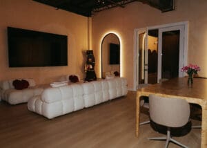 Solace Studio lounge and meeting space with wood table, chairs, and warm natural light photographed for Orlando wellness branding photography.