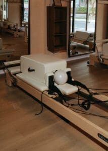 Pilates reformers arranged inside Solace Studio in Orlando with warm lighting and arched mirrors for wellness branding photography.