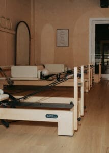 Pilates reformers arranged inside Solace Studio in Orlando with warm lighting and arched mirrors for wellness branding photography.
